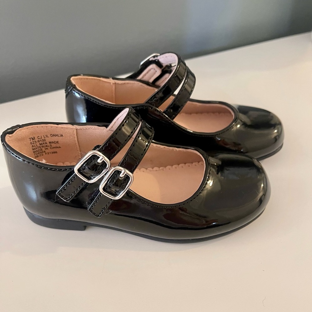 Girls dress shoes, black patent with silver buckles.